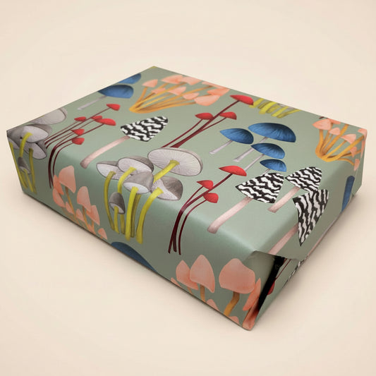 Gift box with colorful mushroom design on a beige background