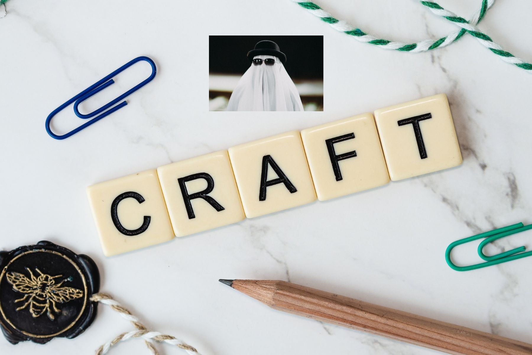 Image of the word, "Craft" spelled out with Scrabble-like letters, other craft supplies, and mystery. 