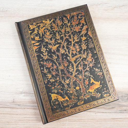 Image of the Persian Grove hardcover journal laying on a desk