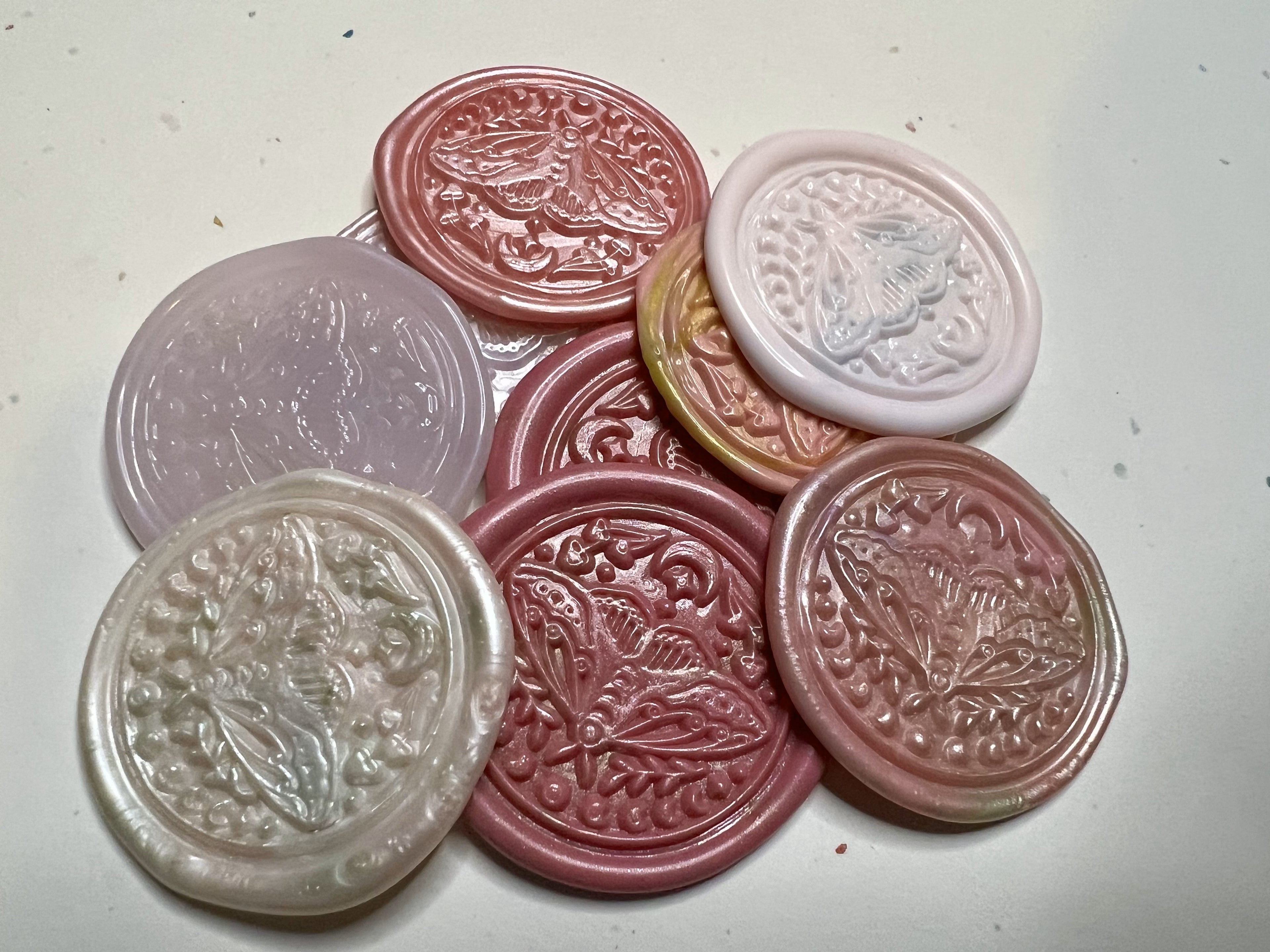 Pink wax seal sticker featuring a delicate lunar moth, great for enchanted or romantic correspondence