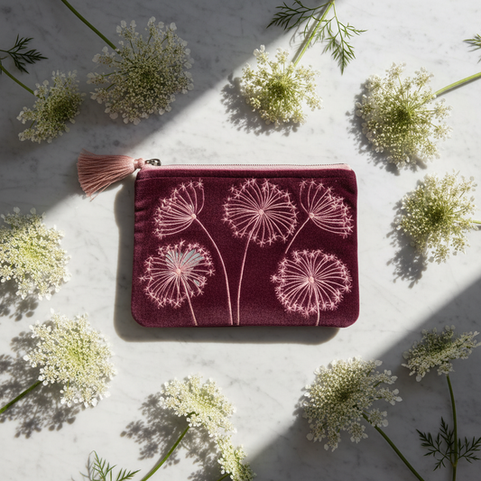 Dark velvet pouch with Queen Anne's Lace design on a beige background with Queen Anne's lace flowers