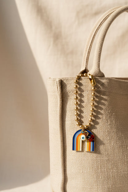 Rainbow bag charm with an evil eye and ladybug with gold clasp