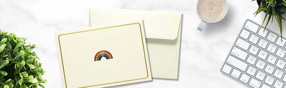 Rainbow notecard laying flat on desk with self seal envelope