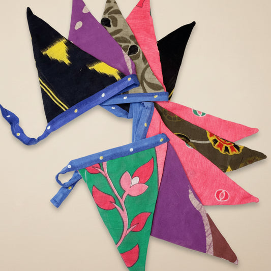 Colorful fabric sari pennants on a white background