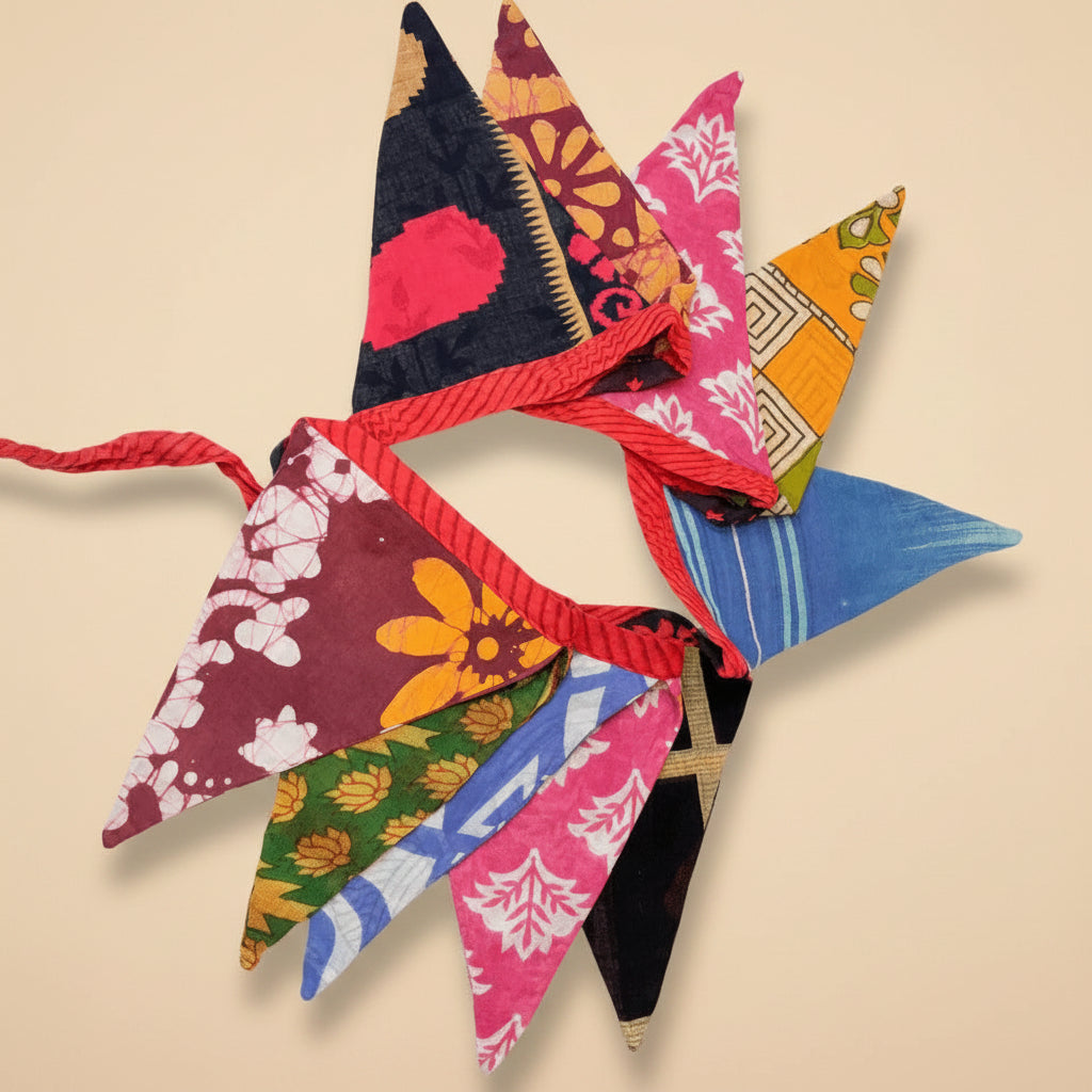 Colorful fabric triangle garland with various patterns on a white background