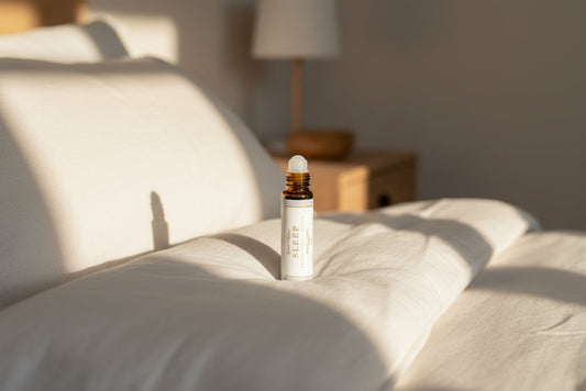 Roll-on bottle labeled 'Sleep' on a bed with a  beige background