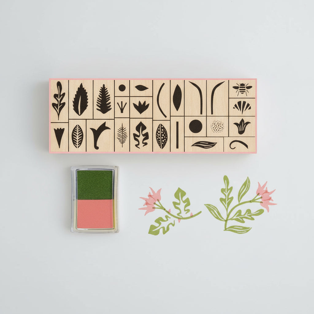 Botanical rubber stamp set in a matchbox-style box with floral illustrations and soft-toned ink pads