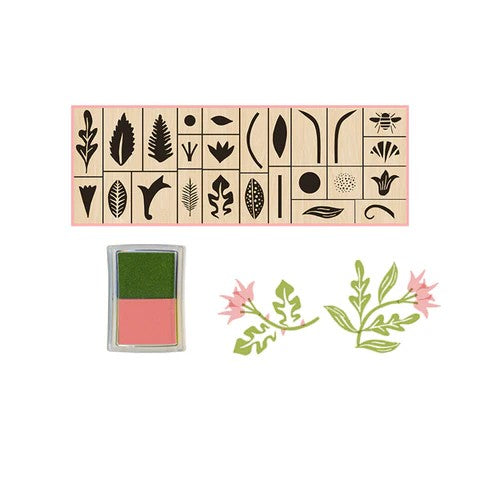 Botanical rubber stamp set in a matchbox-style box with floral illustrations and soft-toned ink pads