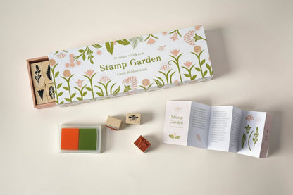 Botanical rubber stamp set in a matchbox-style box with floral illustrations and soft-toned ink pads