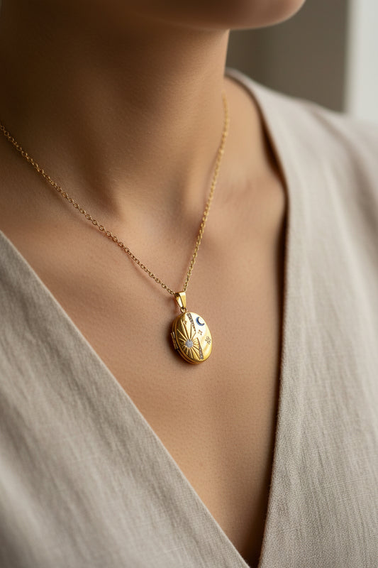 Gold locket necklace with celestial design being worn in a lifestyle shot