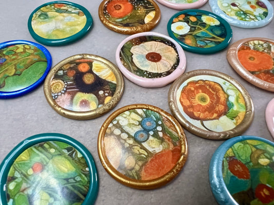 Nature-inspired wax seals featuring floral motifs in pastel hues for crafts and stationery.