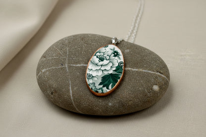 Necklace with a floral pendant on a stone surface