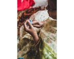 Image of an Indian woman crafting the Embroidered Star Garland by hand