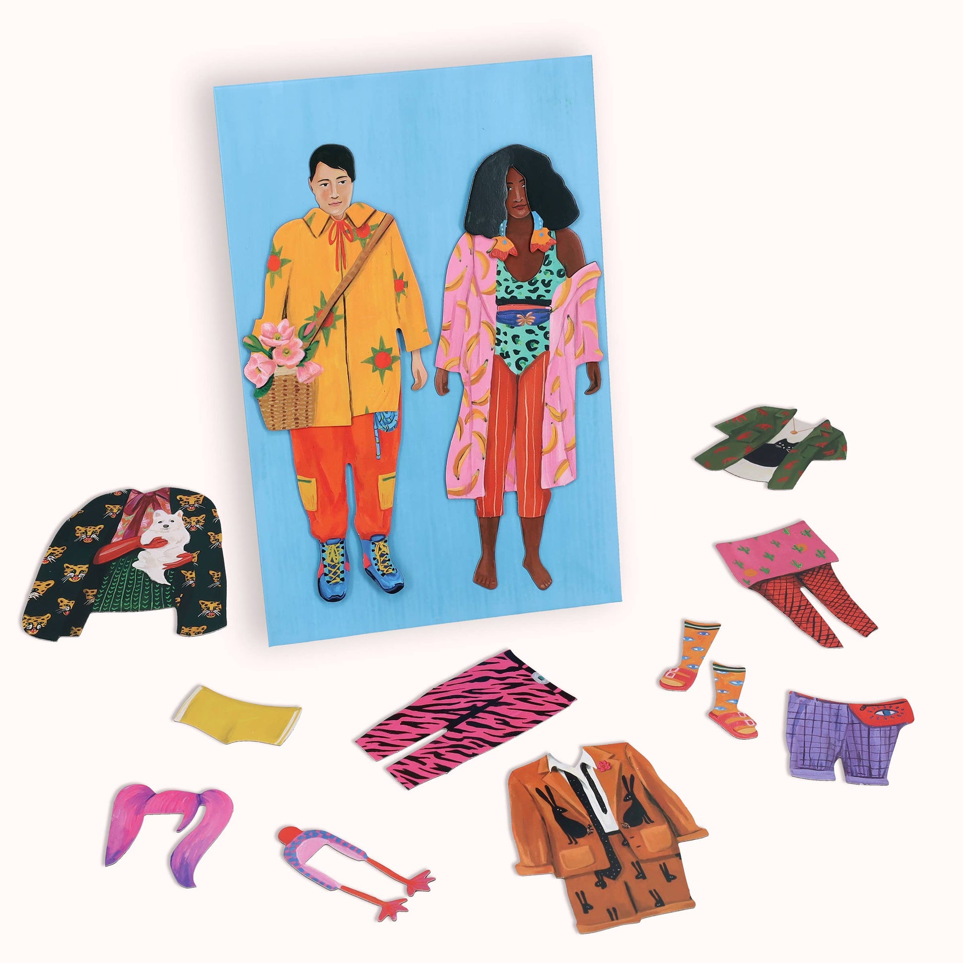 Colorful magnetic dolls with accessories on a white background