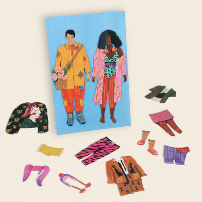 Colorful magnetic dolls with accessories on a white background