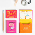 Colorful affirmation cards with a pencil on a white background