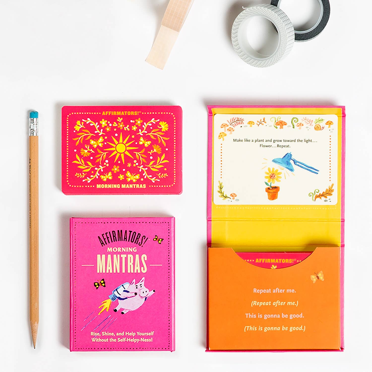 Colorful affirmation cards with a pencil on a white background