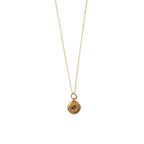 Gold necklace with a compass pendant on a white background