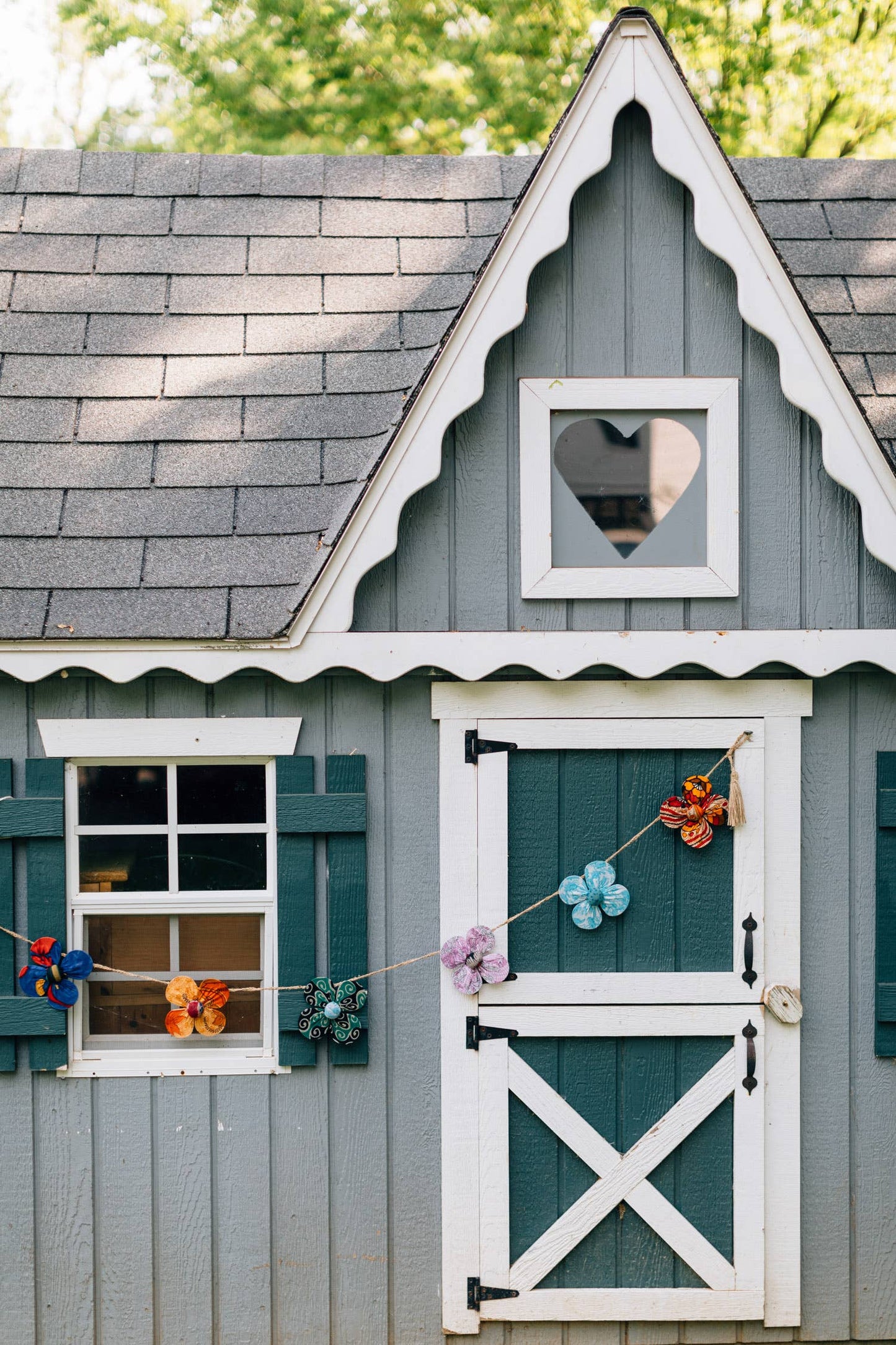 Garland styled across a child's playhouse - each comes with reversible flower details
