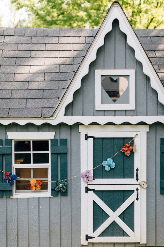 Garland styled across a child's playhouse - each comes with reversible flower details