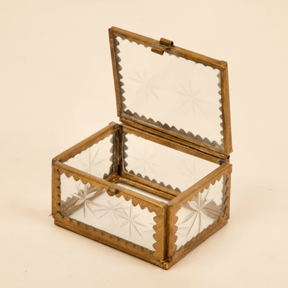 A brass and etched glass box, perfect for holding jewelry on a white background
