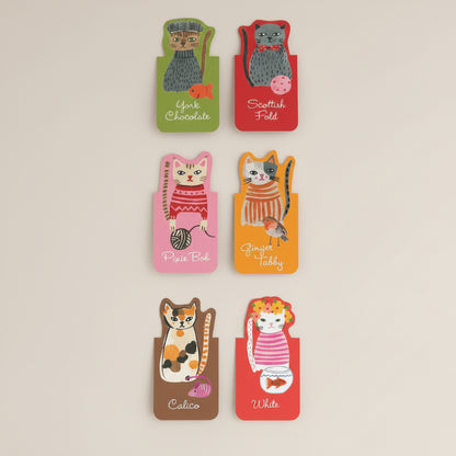 Close-up of illustrated feline designs with unique facial expressions