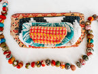 Colorful pouch with patterned contents on a white background