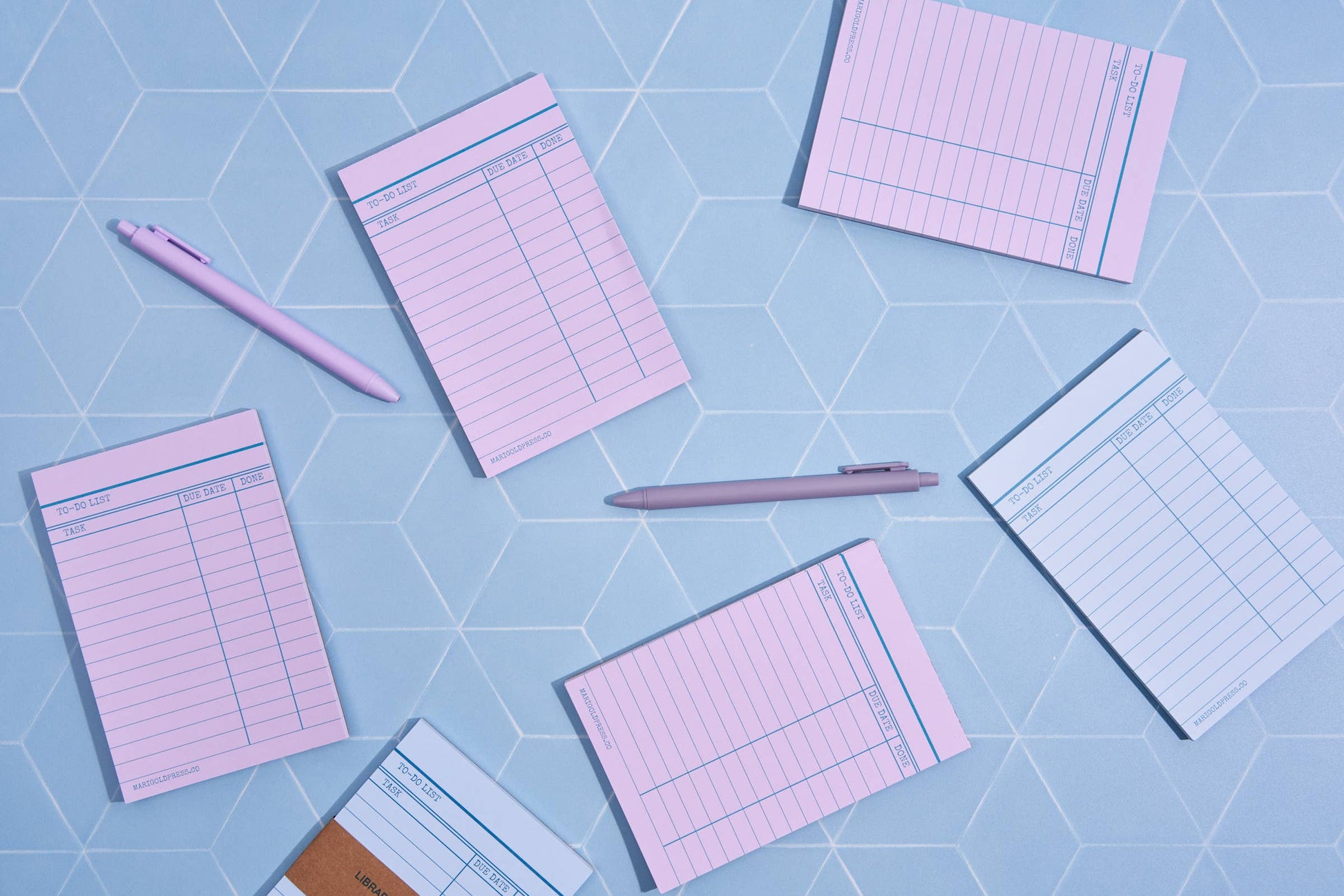 Blue library card notepad styled with a blue background and purple library notepads and pens