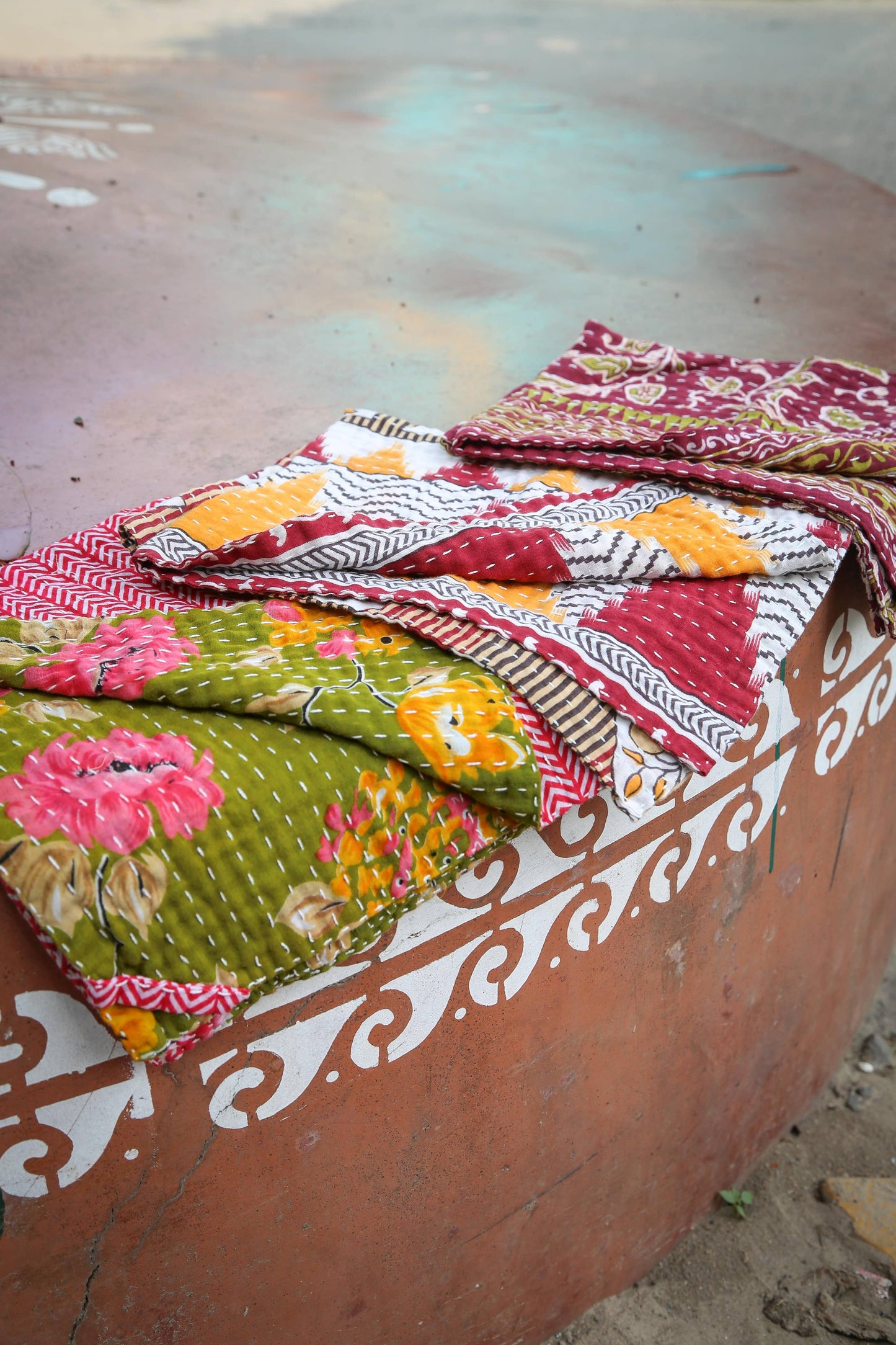 Colorful patterned fabrics on a textured surface