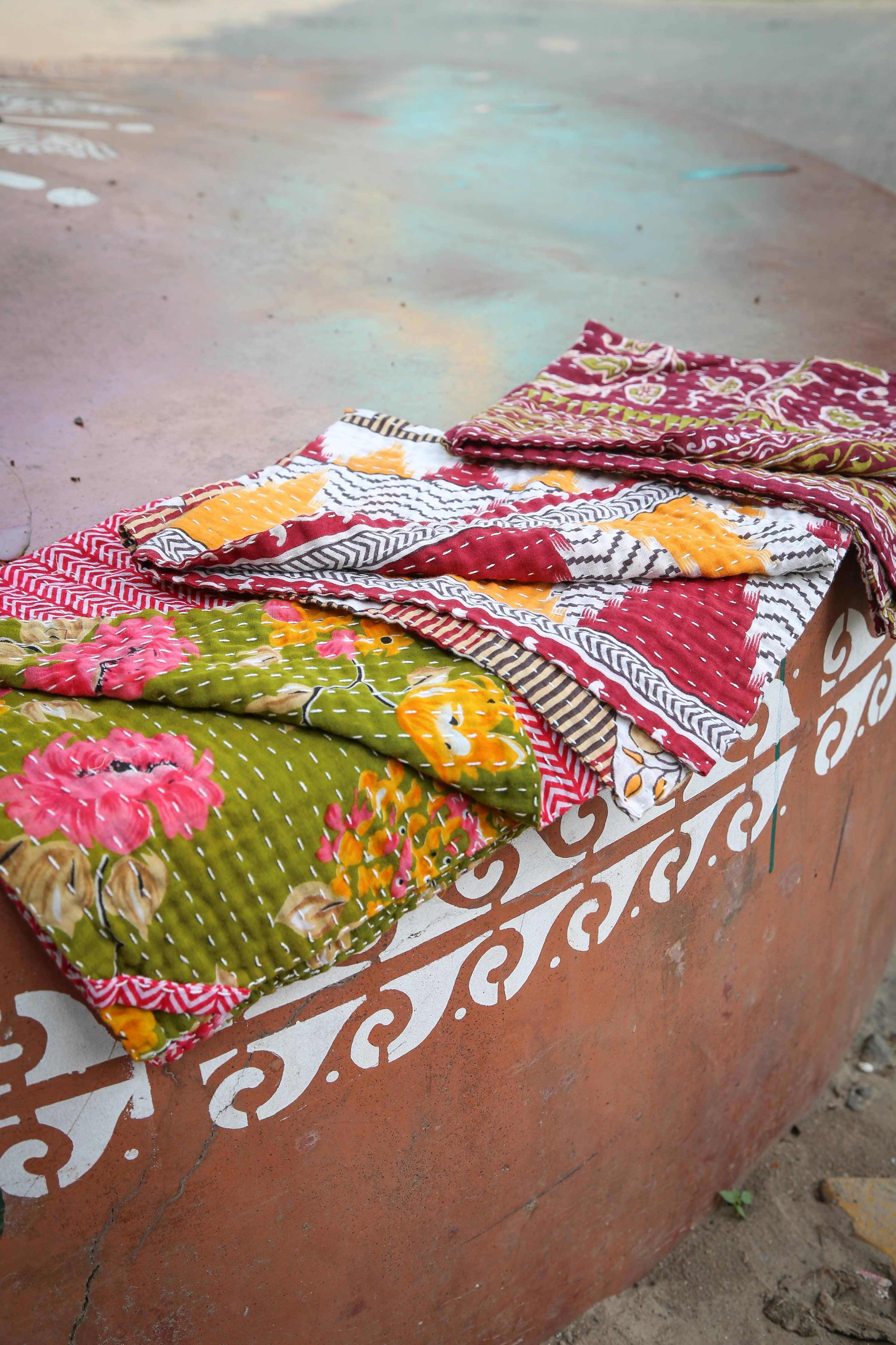 Colorful patterned fabrics on a textured surface