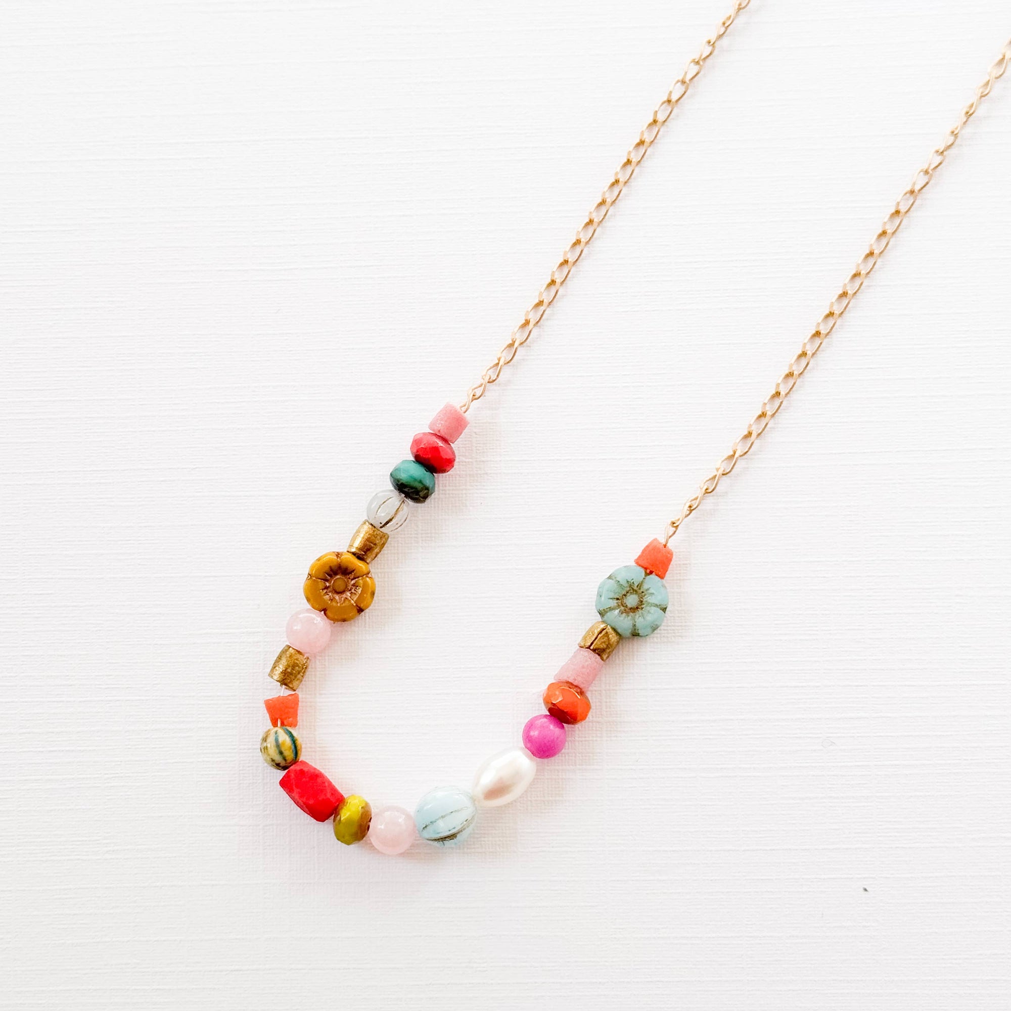 Necklace layers with other dainty gold chains and jewelry