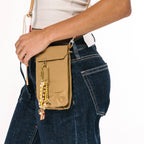 Keychain attached to a leather side bag, showing scale and color contrast