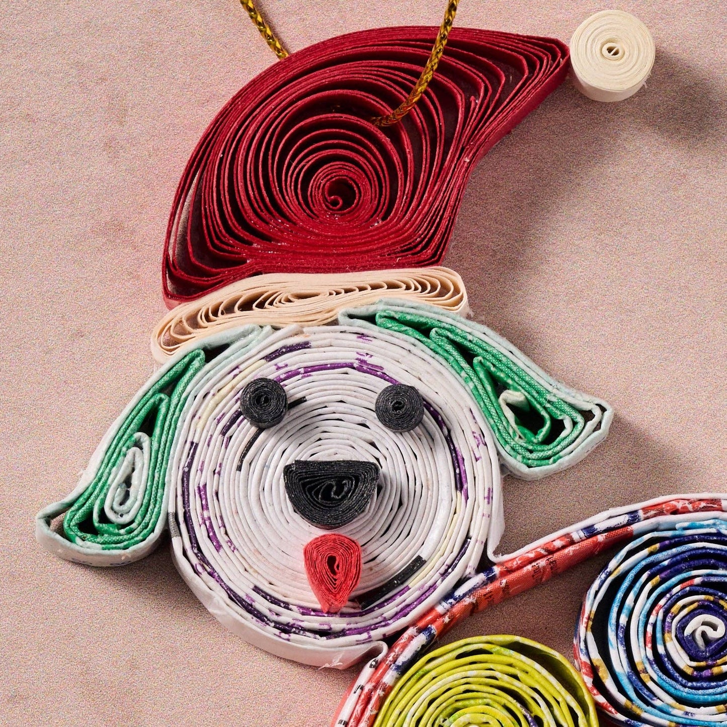 Close up view of the colorful paper sculpture of a dog with a beige background
