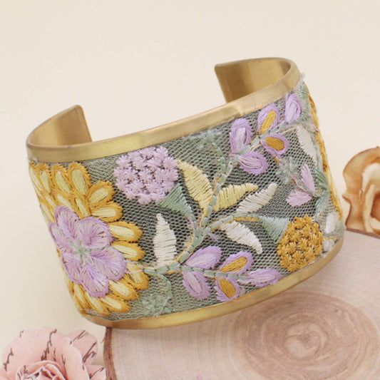 Floral embroidered cuff bracelet on a light background