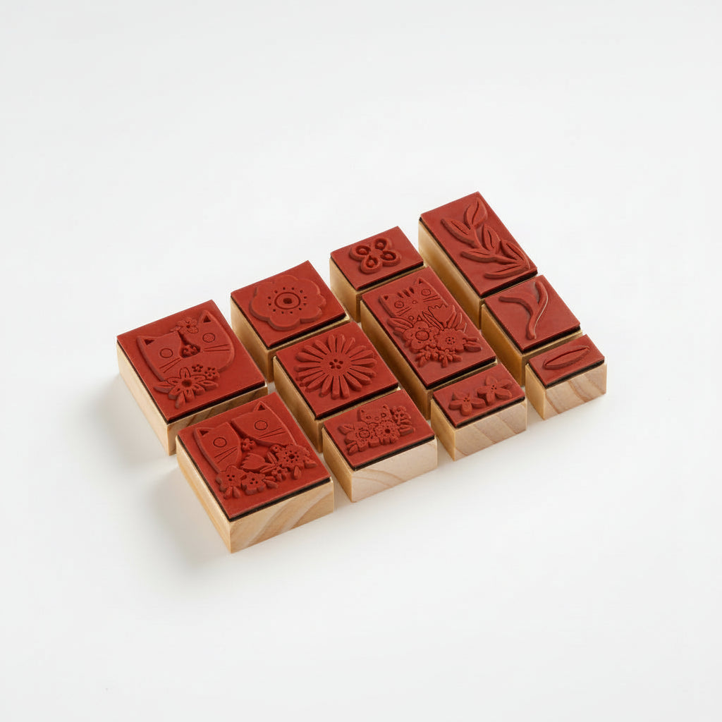 Set of wooden stamps with red ink pads on a white background