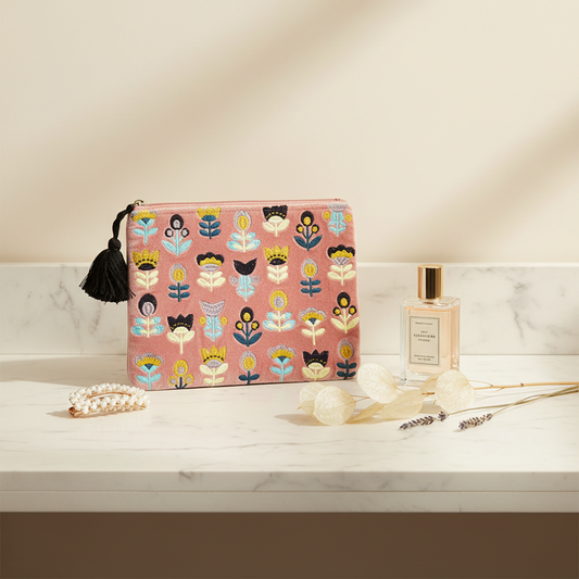 The large Handmade Floral Pouch with Tulips on Pink Embroidered Coin Purse displayed on a bathroom counter, perfume bottle, hair clip on a bathroom background