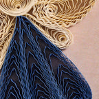 Close-up of textured blue and beige fabric rolls on a beige background