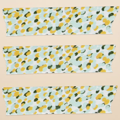 Three strips of fabric with a lemon pattern on a light blue background