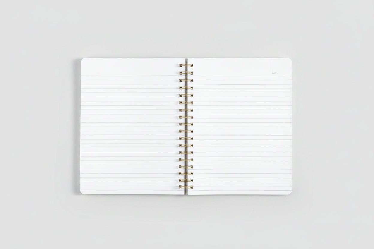 Open notebook with spiral binding on a white background