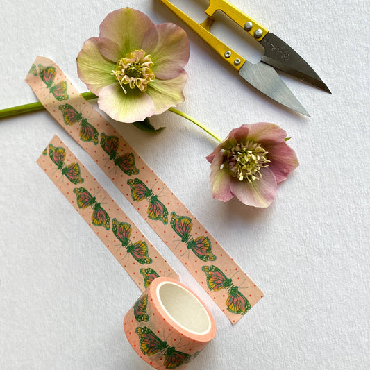 Overhead shot of tape in a flat lay with scissors and dried flowers