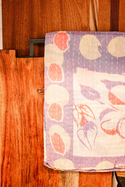 Colorful towel with neutral abstract patterns hanging on a wooden door