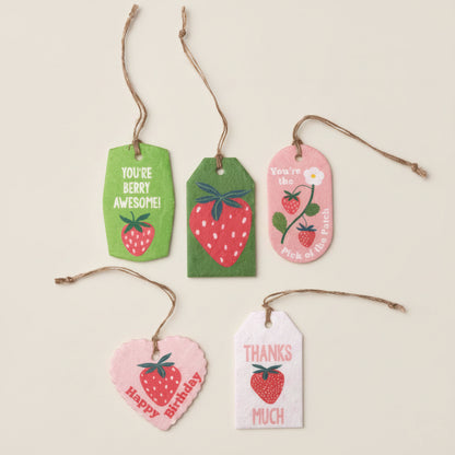 Set of decorative gift tags with strawberry designs and text on a white background