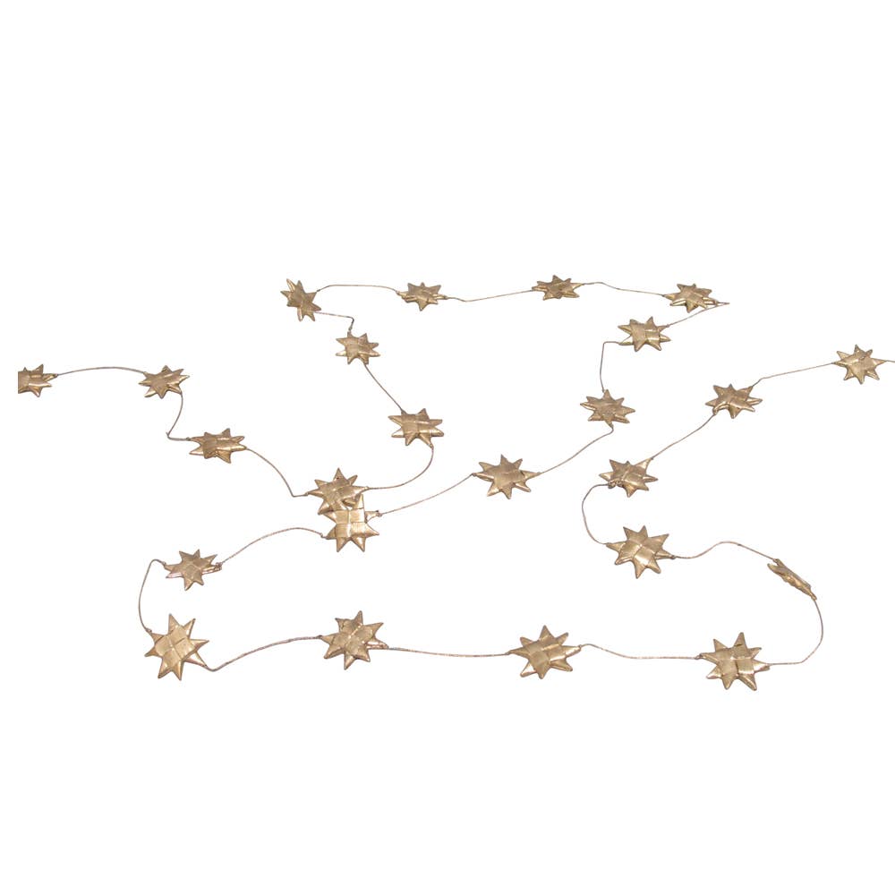 A gold palm leaf star garland displayed on a white background