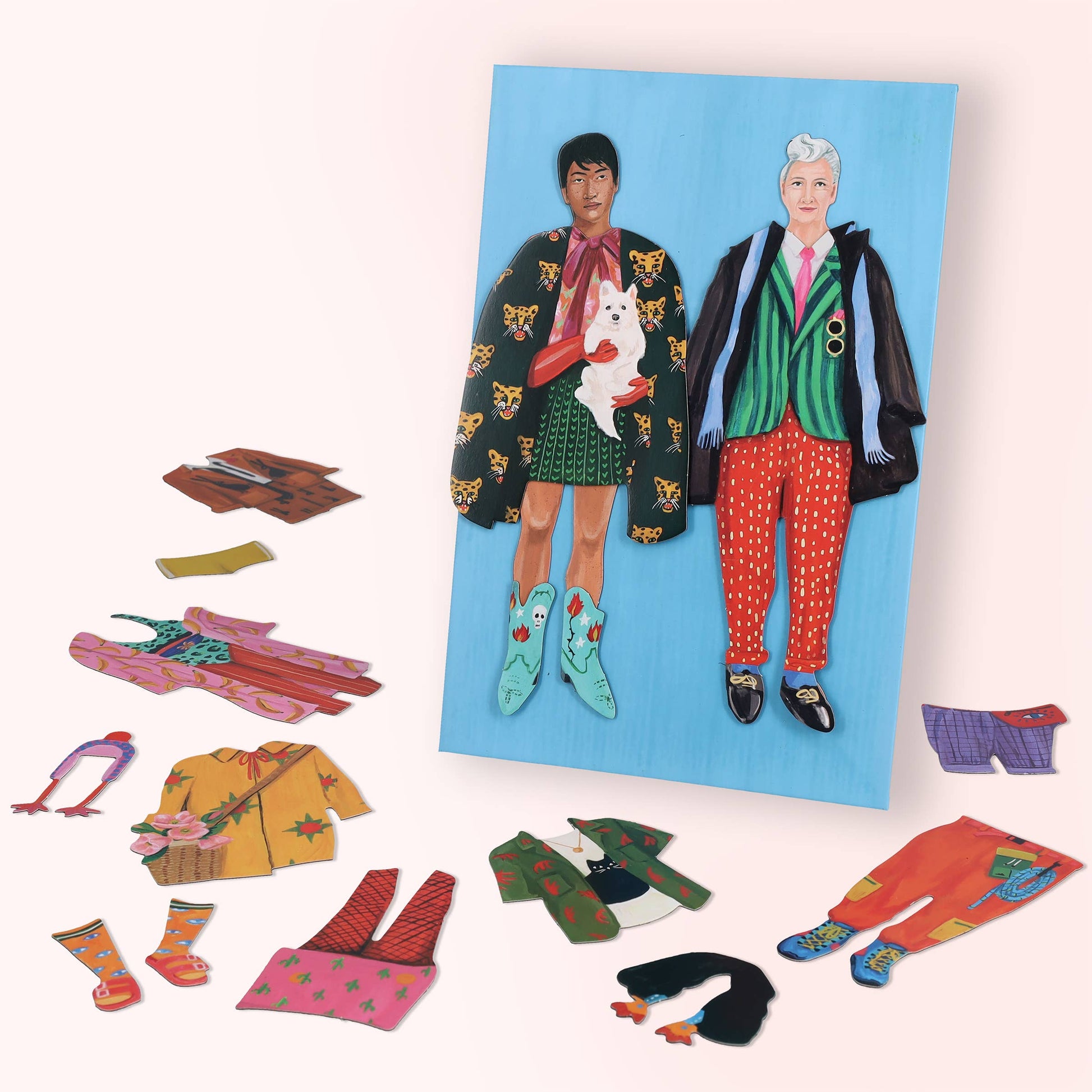 Set of magnetic dolls with interchangeable colorful outfits on a blue background