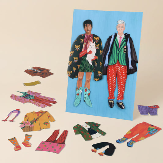 Set of magnetic dolls with interchangeable colorful outfits on a blue background