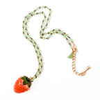 Strawberry necklace displayed coiled in a spiral, highlighting its adjustable length and lobster clasp