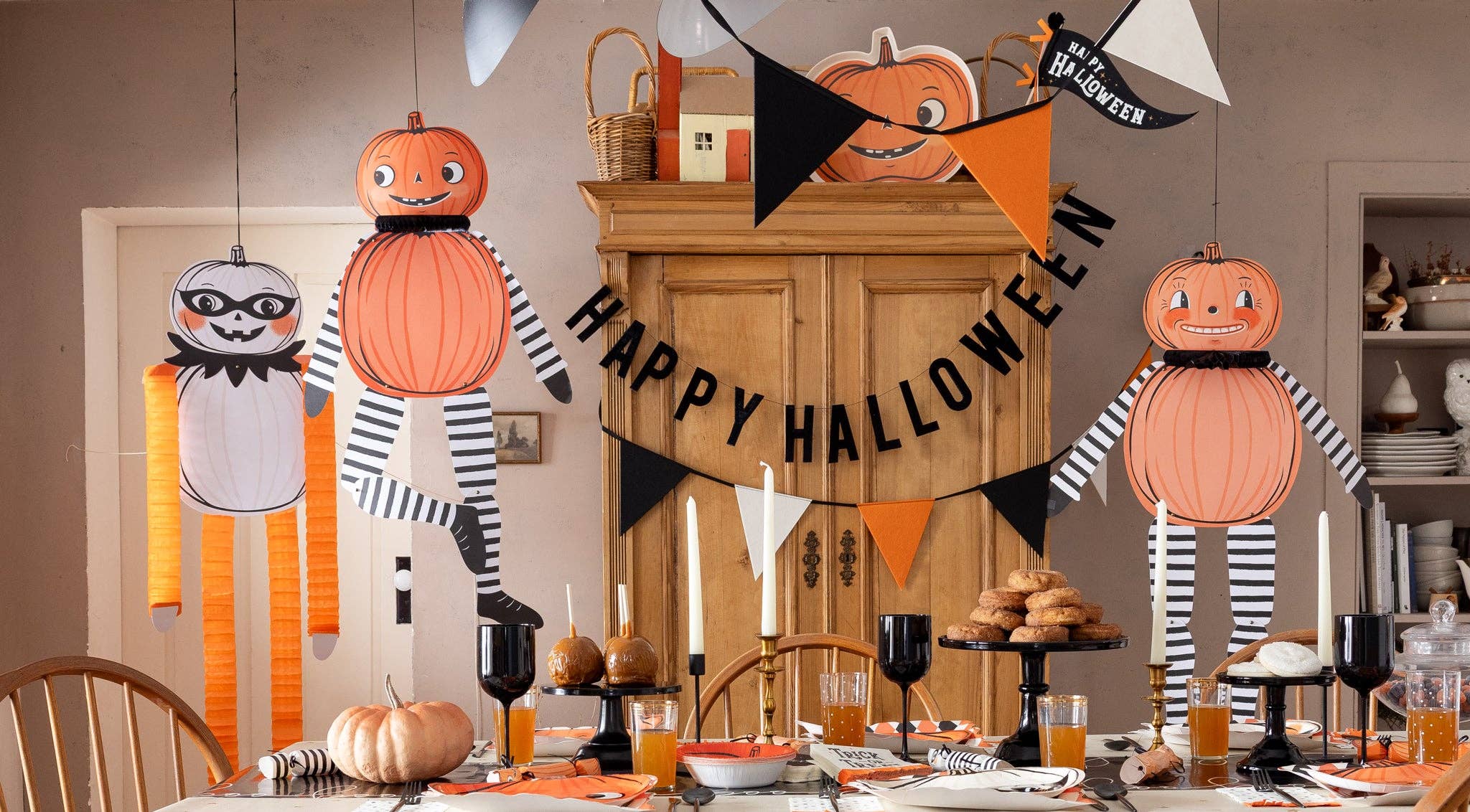 Retro Halloween decorations hanging from twine in a festive space