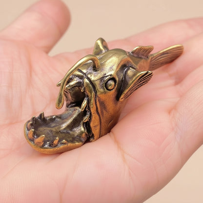 Bronze Anglerfish being held in a person's hand.