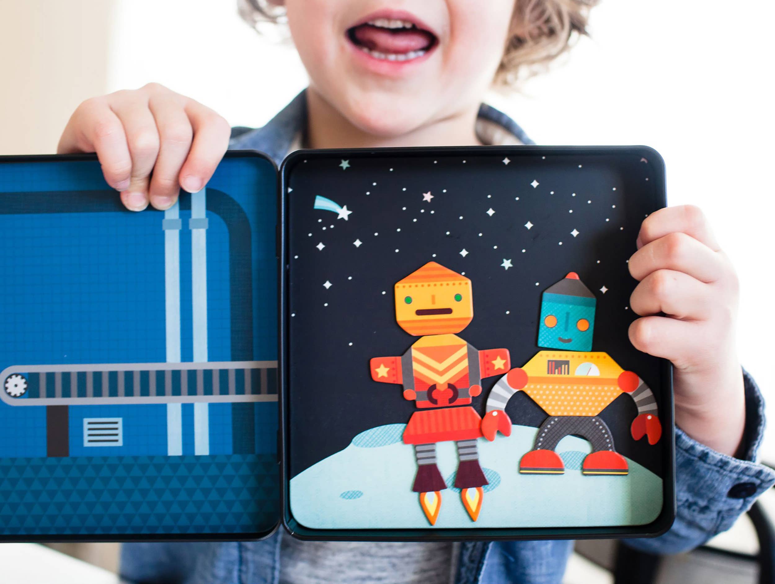 Open tin showing robot character pieces on colorful play scene