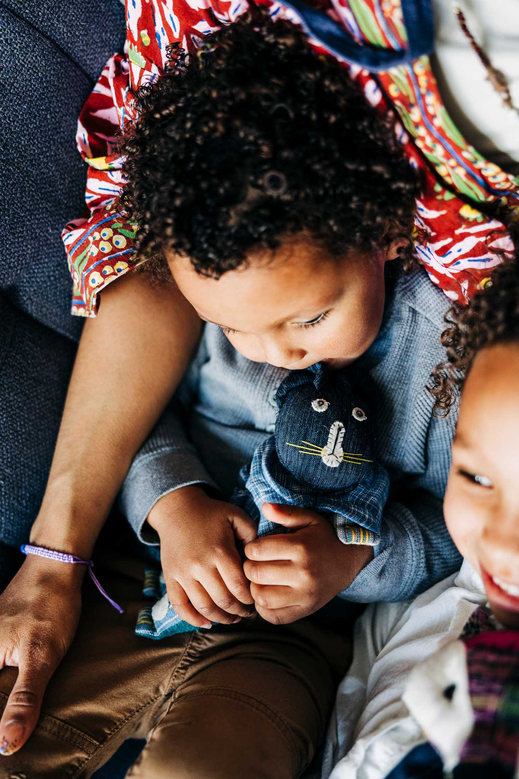 Soft cotton cat-shaped eye pillow being enjoyed by a happy  child